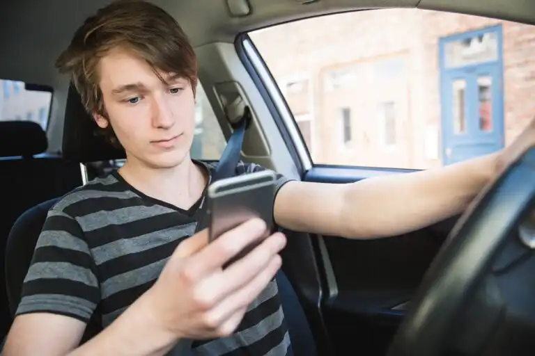 Teenage boy and new driver behind wheel of his car
