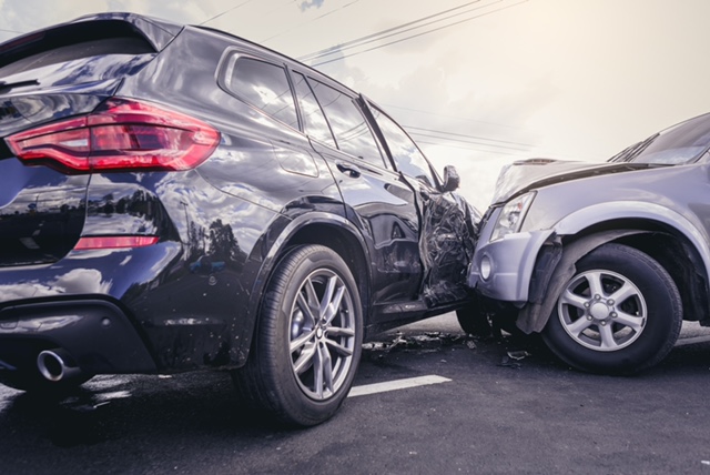 Car crash dangerous accident on the road. SUV car crashing beside another one on the road.