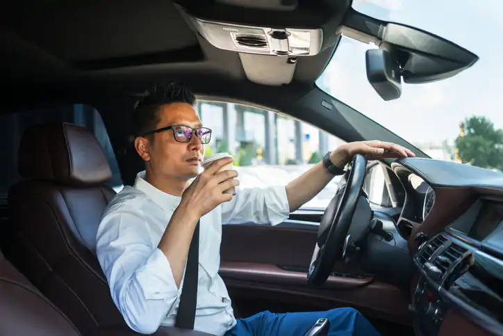 Chinese businessman draving a car