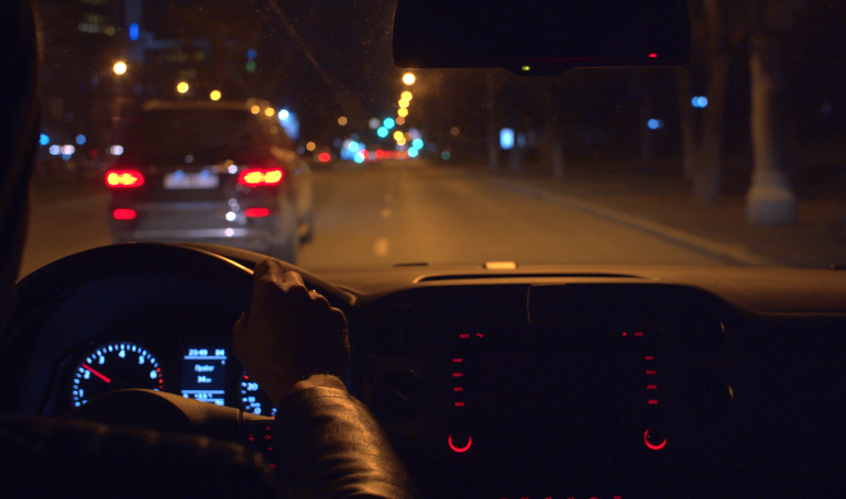 Hands on the steering wheel of a car